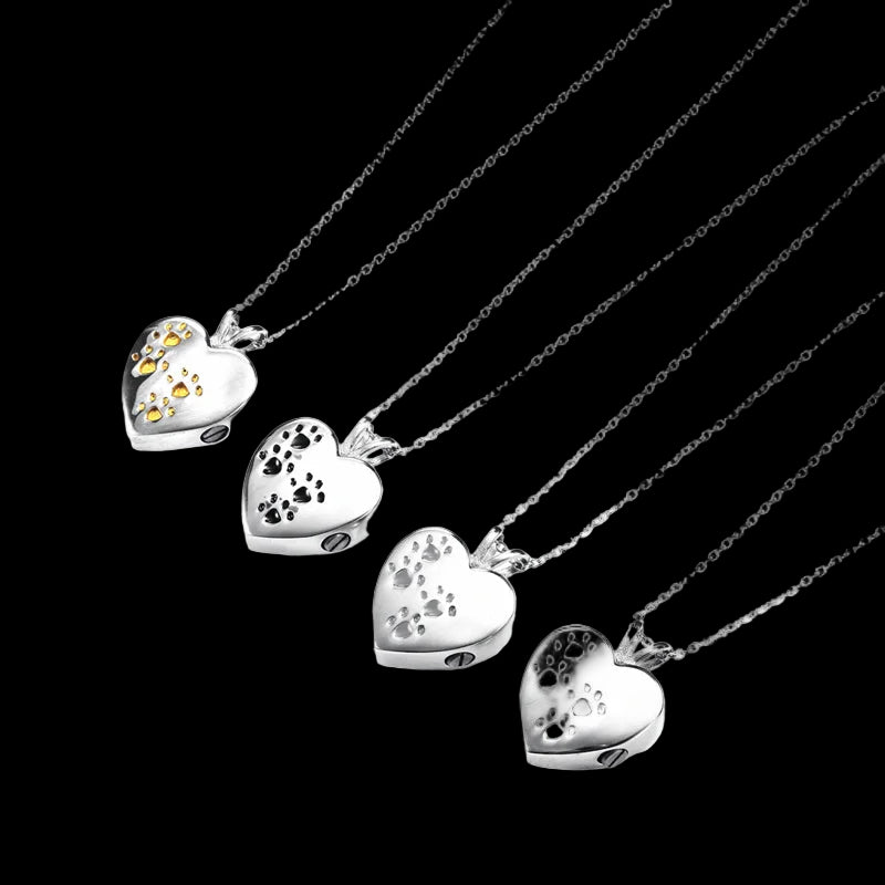 Set of silver heart-shaped pendants on thin chains against a white background