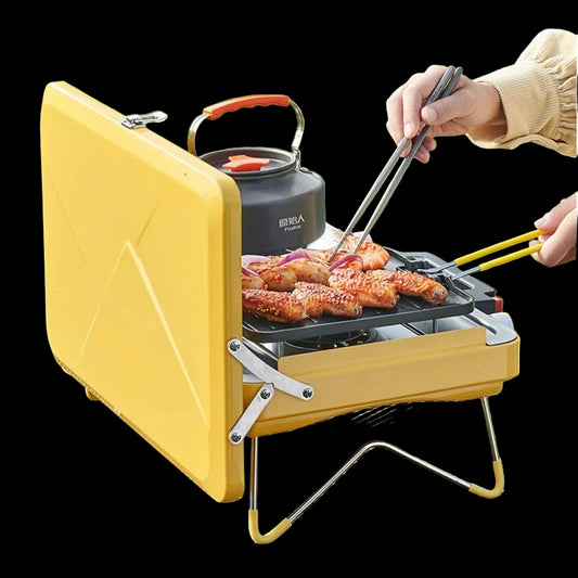 Yellow portable grill with food being cooked outdoors