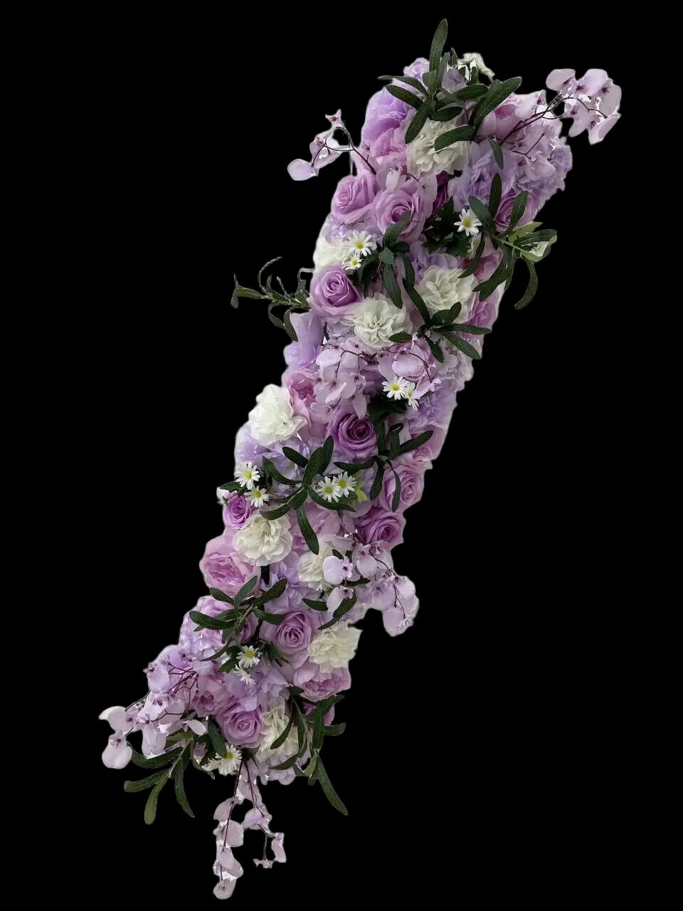 Decorative floral arrangement on a white wall with a ladder