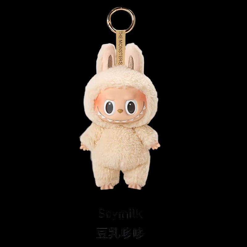 Plush keychain in a beige costume with 'The Monsters' branding on a white background