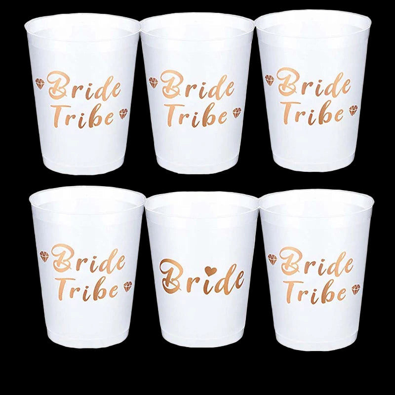 Set of six white cups with 'Bride Tribe' and 'Bride' text in gold, with one additional cup labeled 'Bride'.