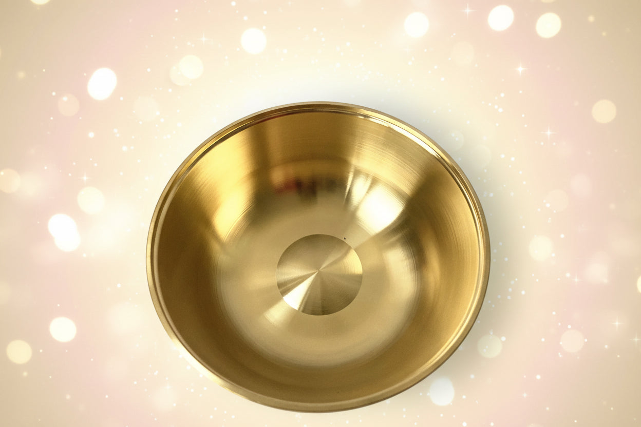 Gold metal bowl on a white background