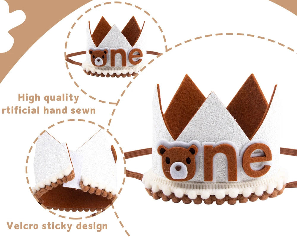Brown and white crown-shaped decorative item with 'one' and bear design on a beige background