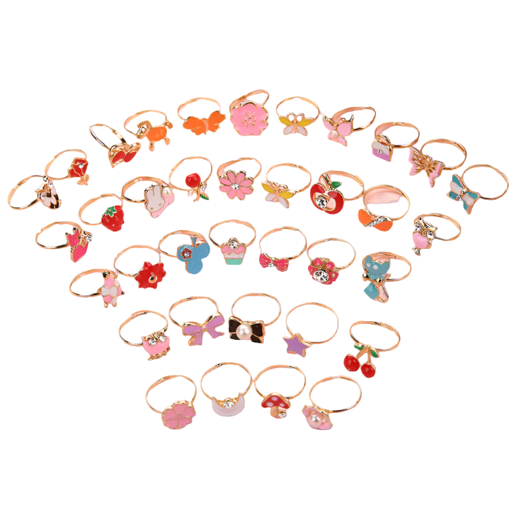 Set of small decorative rings with various designs on a pink surface