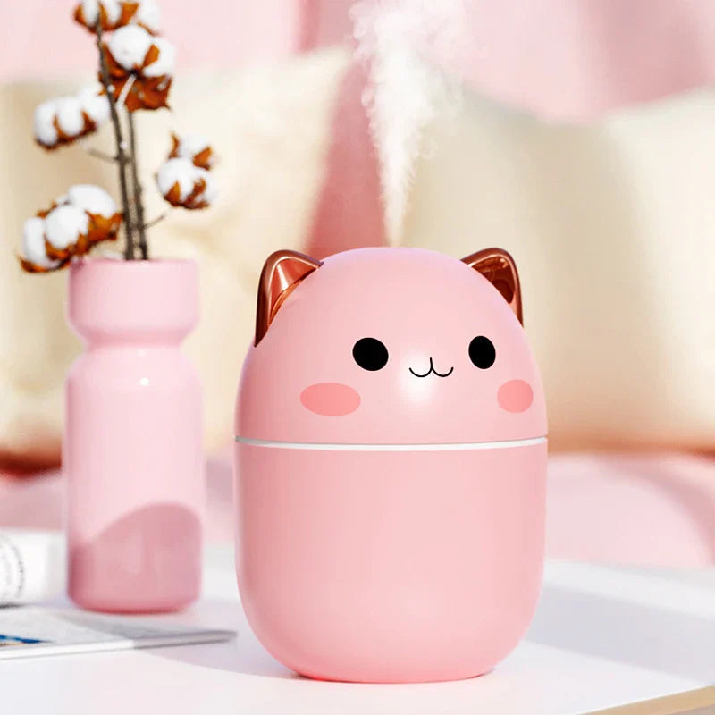 Pink cartoon-style humidifier with cat ears on a blurred background