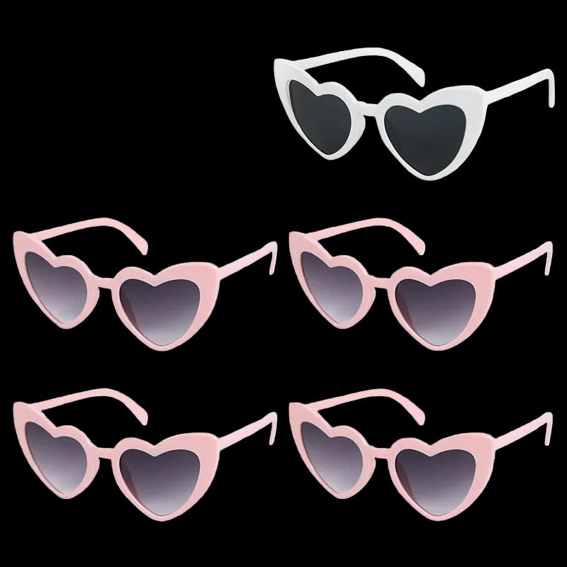 Set of heart-shaped sunglasses with pink frames and black lenses on a white background.