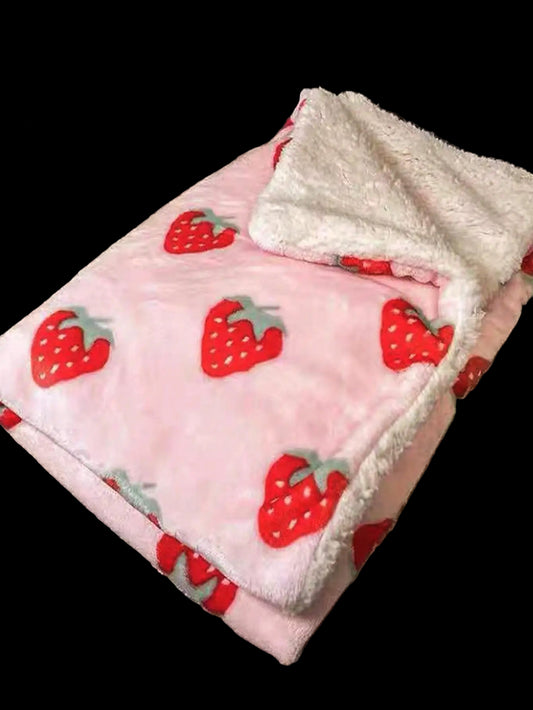 Flannel blanket with strawberry pattern on a textured surface