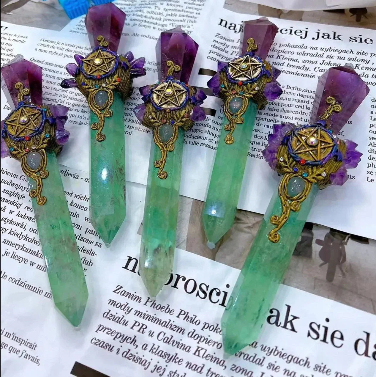 Decorative green crystal sticks with purple ribbons on a newspaper background