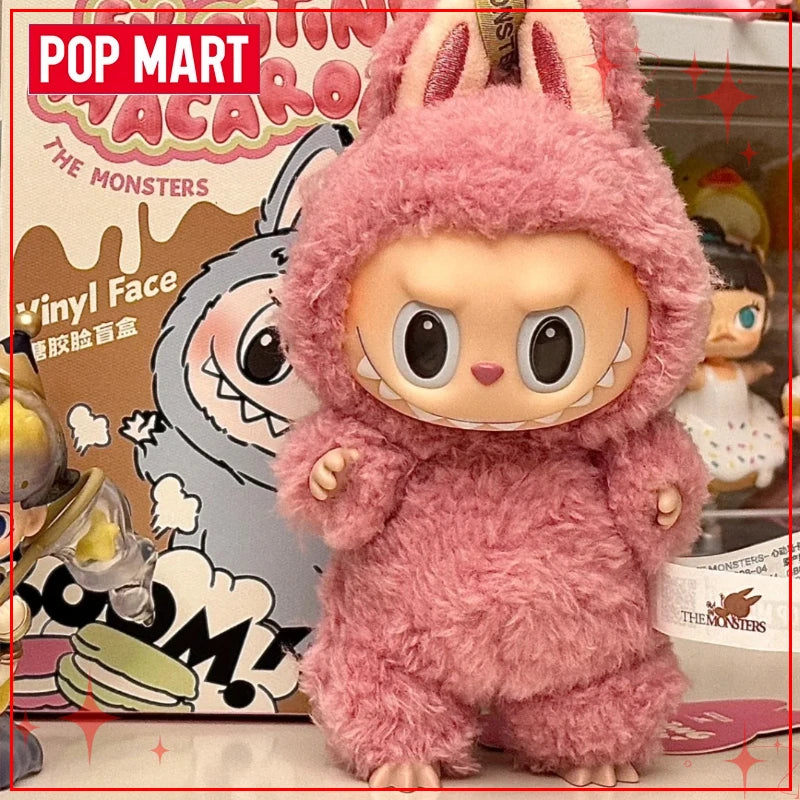 Pink plush toy with bunny ears in front of a Pop Mart branded background