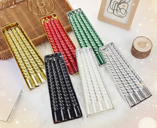 Set of colorful metallic candles on a light background