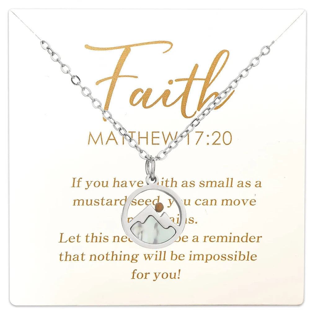 Necklace with a mountain pendant on a card with 'Faith' and Bible verse text.