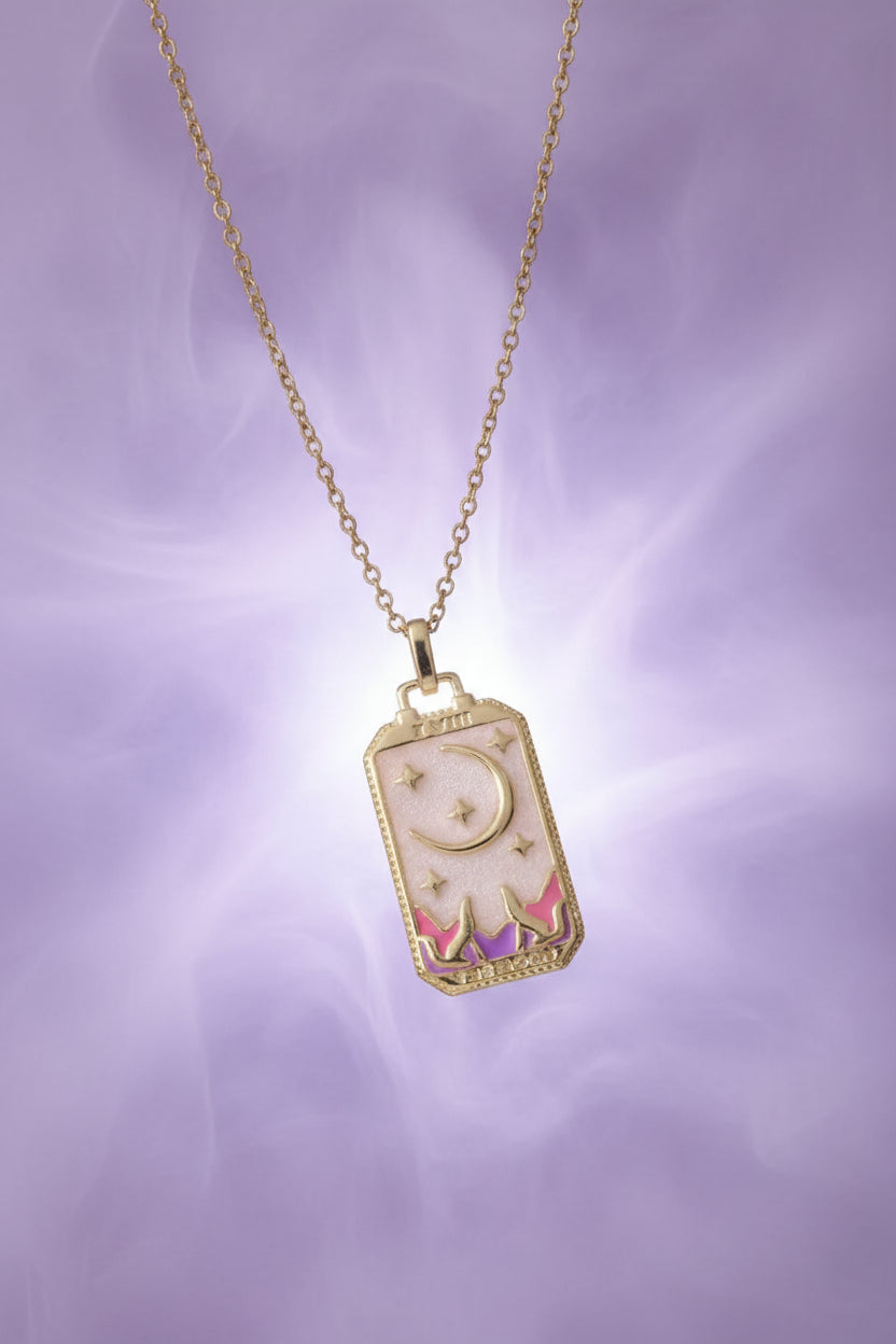 Necklace with a rectangular pendant featuring a colorful design on a textured beige surface.