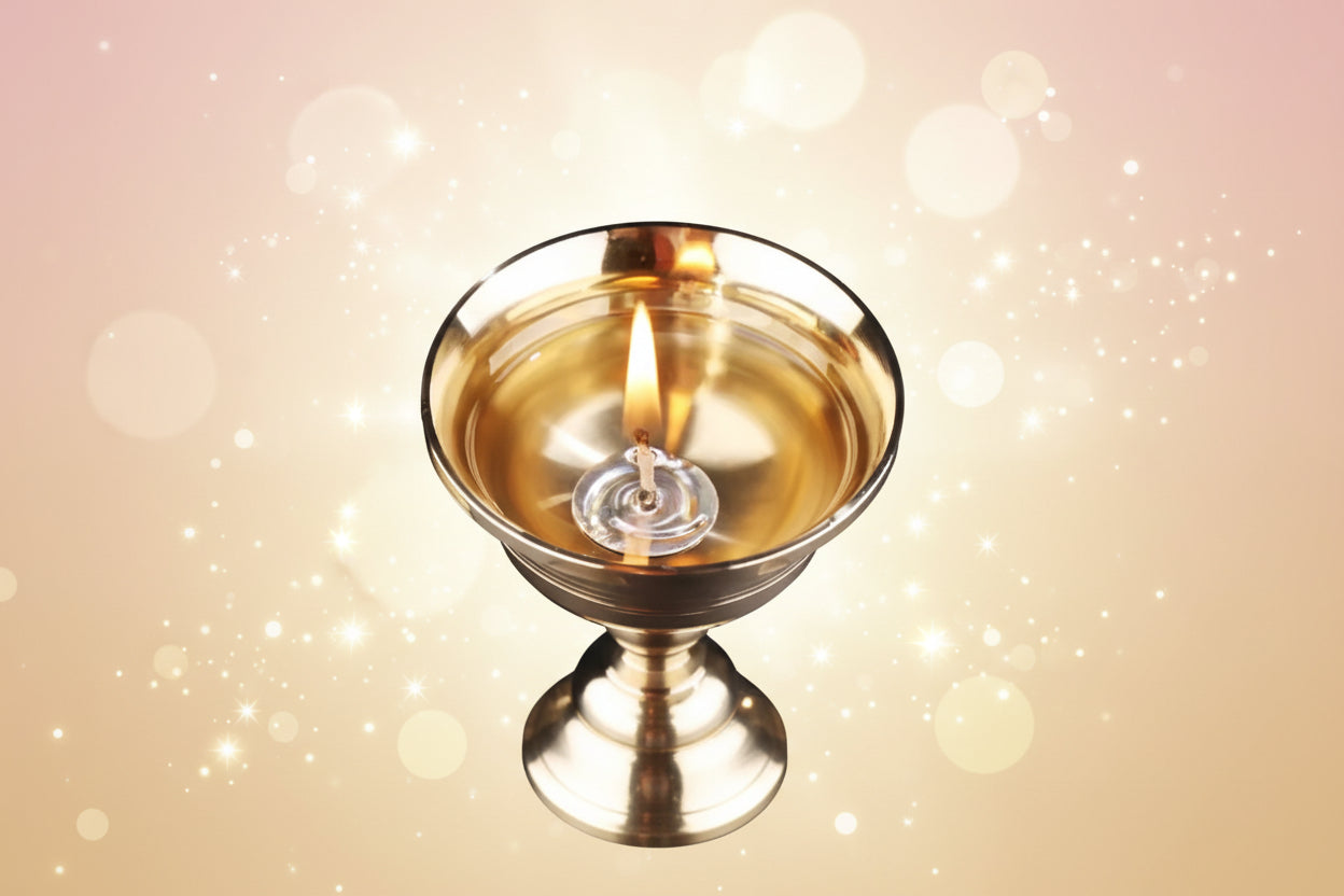 Gold candle holder with a lit candle against a dark background