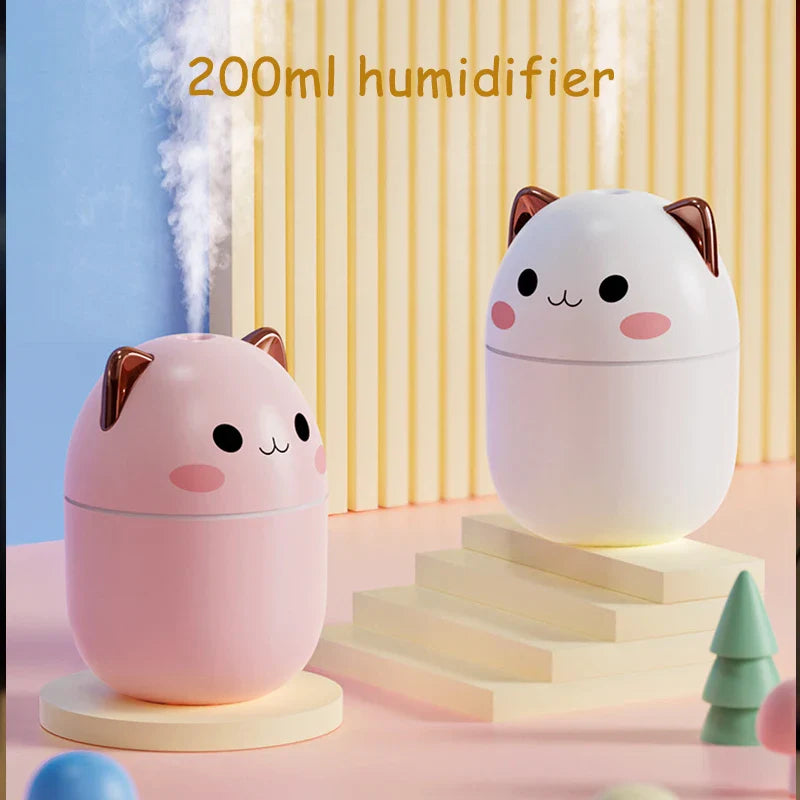 Two cute cat-shaped humidifiers on a colorful background