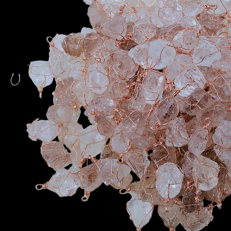 Rose gold and clear crystal beads on a light blue background