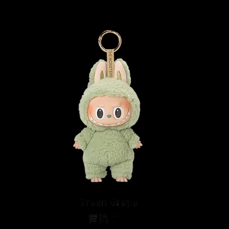Green plush keychain with cartoon character on a white background