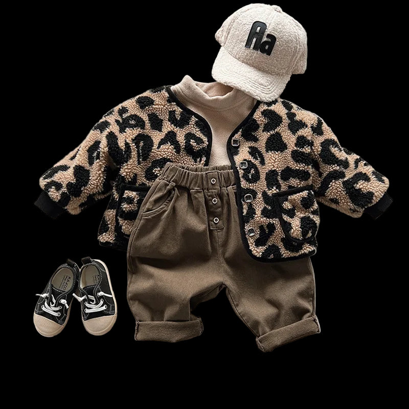 Children's outfit with leopard print jacket, brown pants, and cap on a white surface