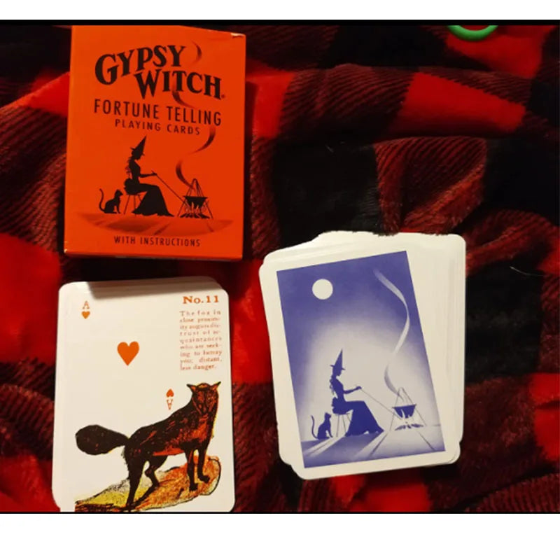 Gypsy Witch fortune telling playing cards with a red box on a plaid fabric background