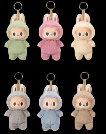 Set of colorful plush keychains on a white background