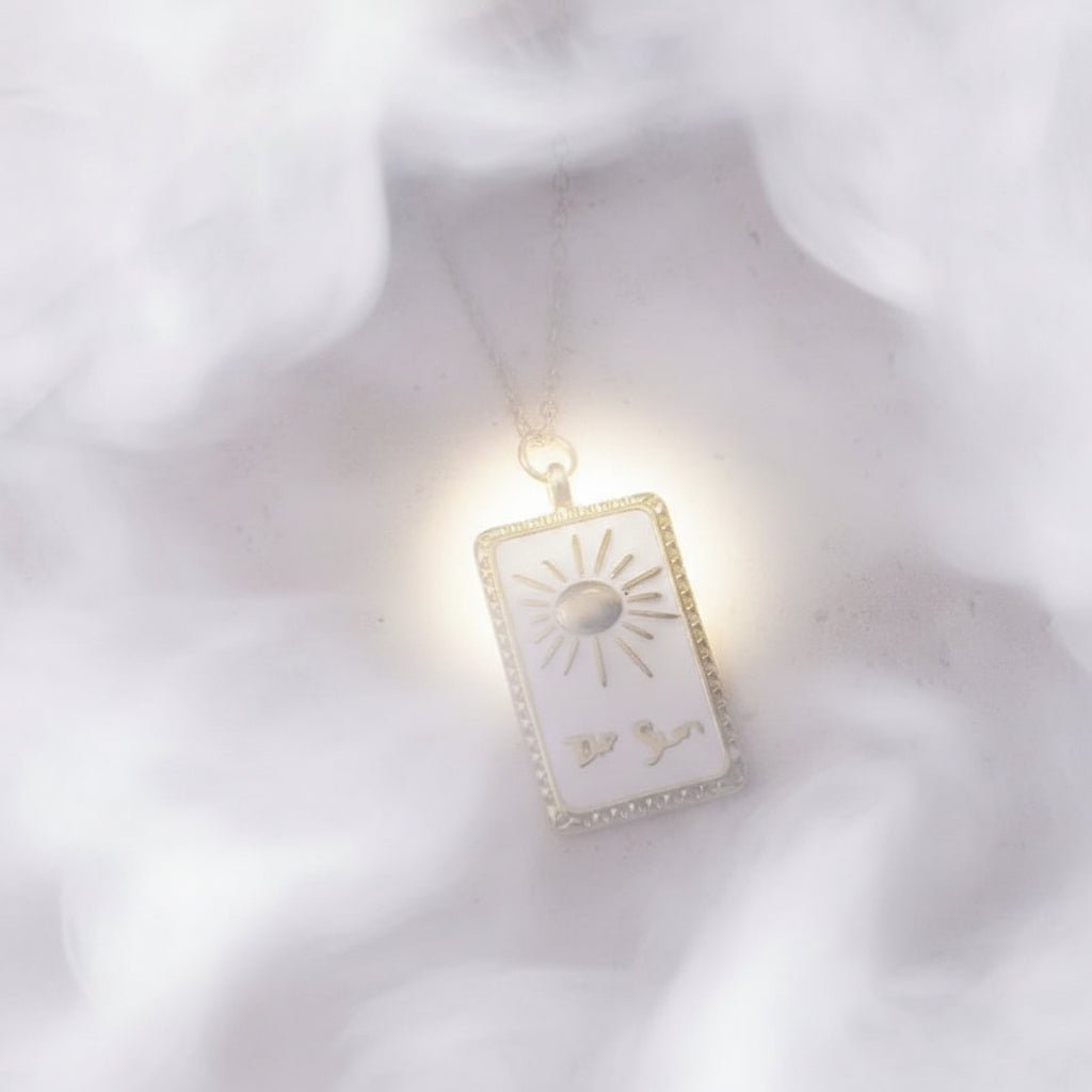 Necklace with a rectangular pendant featuring a sun design on a textured surface