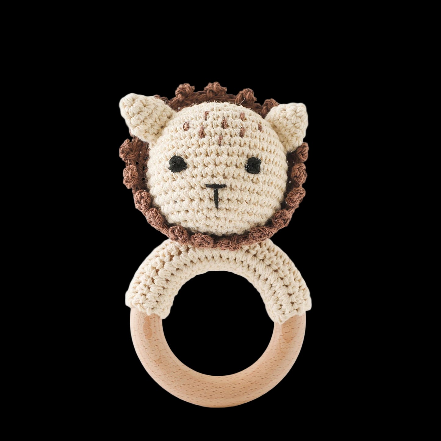 Crocheted lion rattle toy on a white background