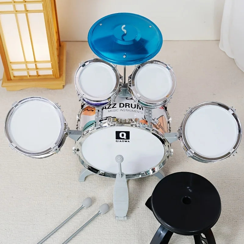 Children's drum set with blue top drum on a light-colored floor.