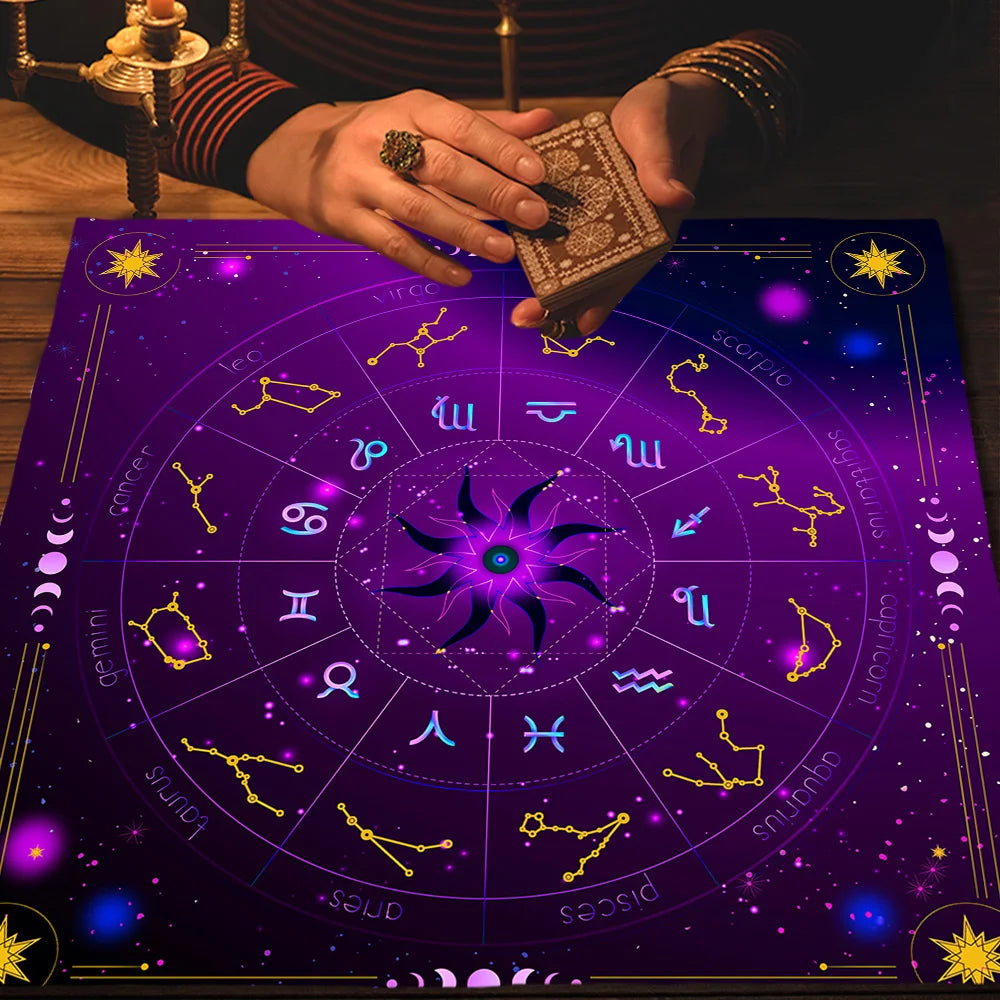 Person holding a deck of cards over a purple astrological chart with star signs.