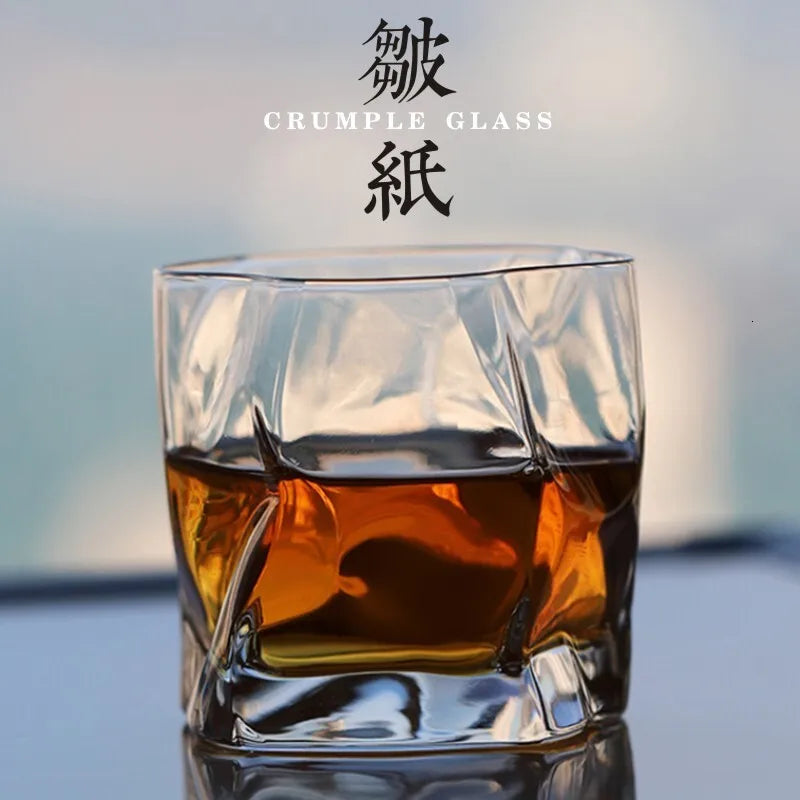 Glass with a drink and 'Crumple Glass' branding on a blurred background