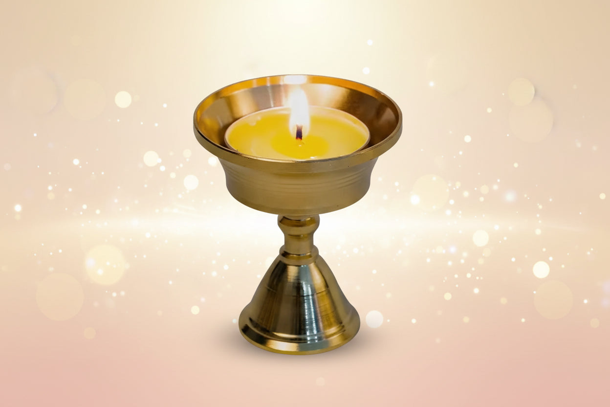 Gold candle holder with a lit candle on a black background