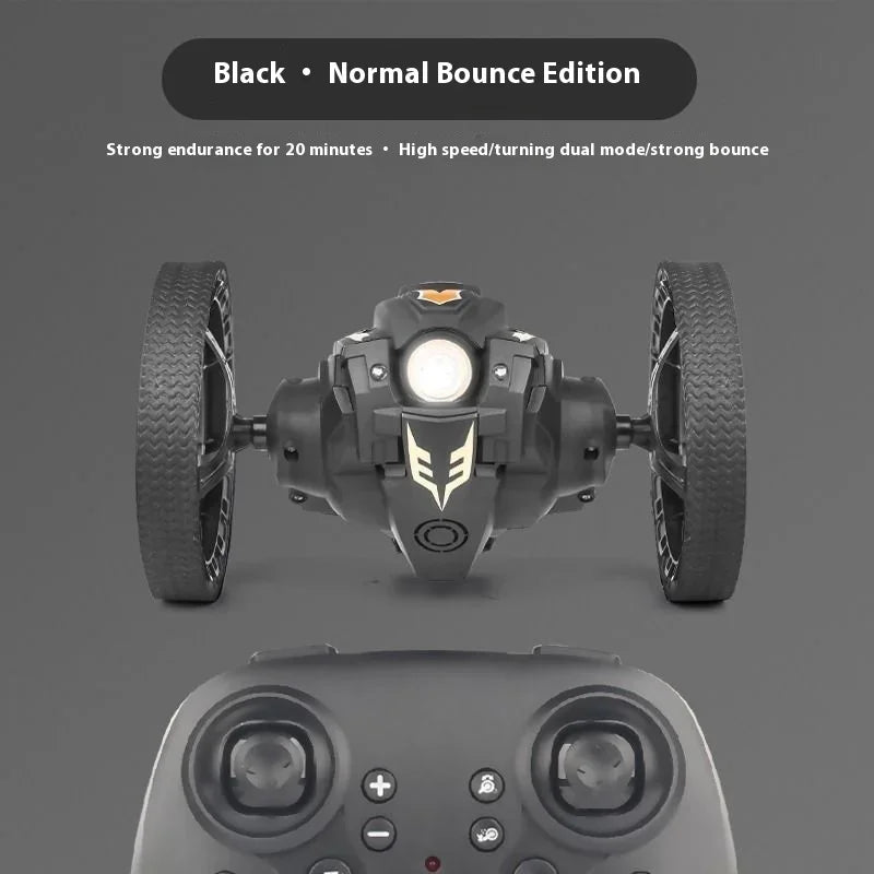 Black remote-controlled vehicle with wheels and a controller on a gray background