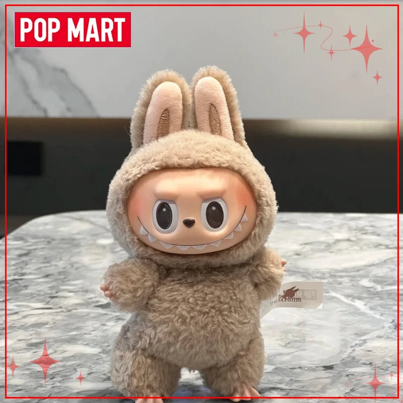 Plush toy with bunny ears and face on a marble surface, branded with Pop Mart.