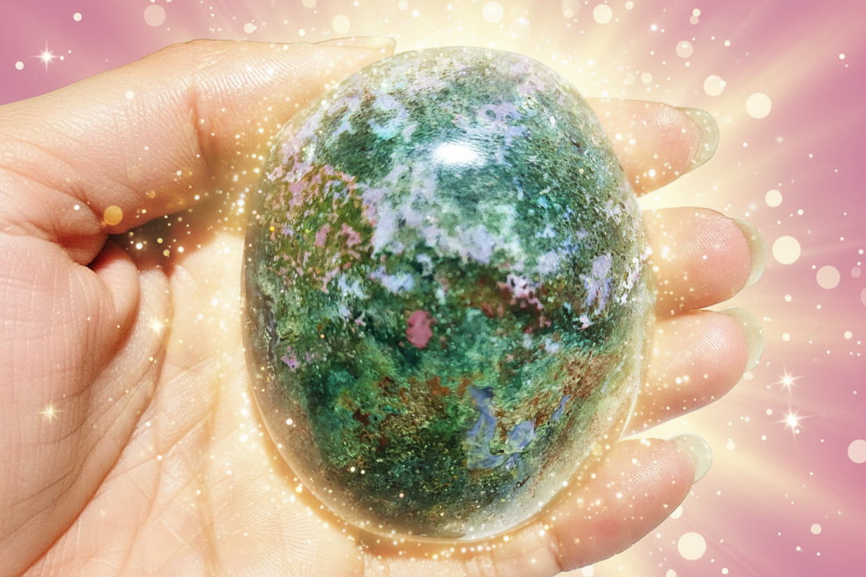 Hand holding a colorful stone with a natural background