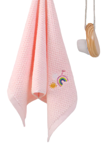 Pink textured towel with embroidery hanging on a white wall with hooks.