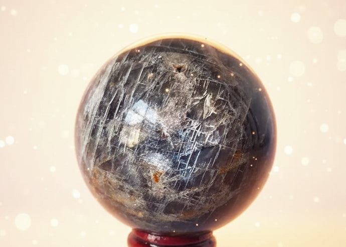 Crystal ball with a wooden stand on a white background