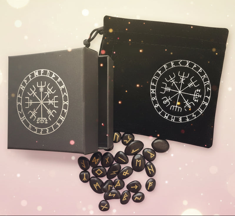 Black stones with gold runes next to a black box with rune designs on a white background