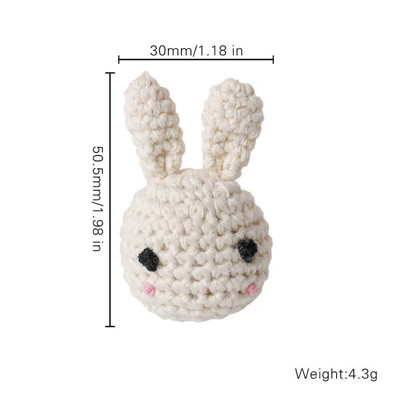 Small crocheted rabbit toy with measurements and weight on a white background