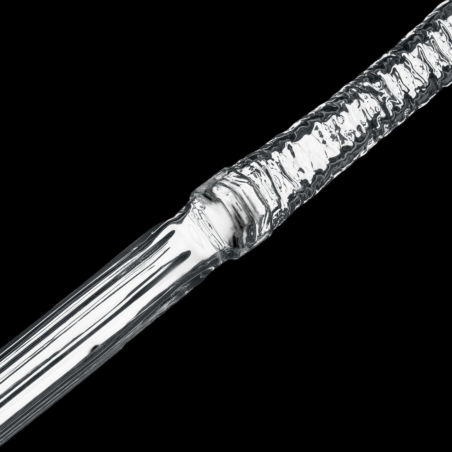 Close-up of a metallic object with a textured surface on a white background