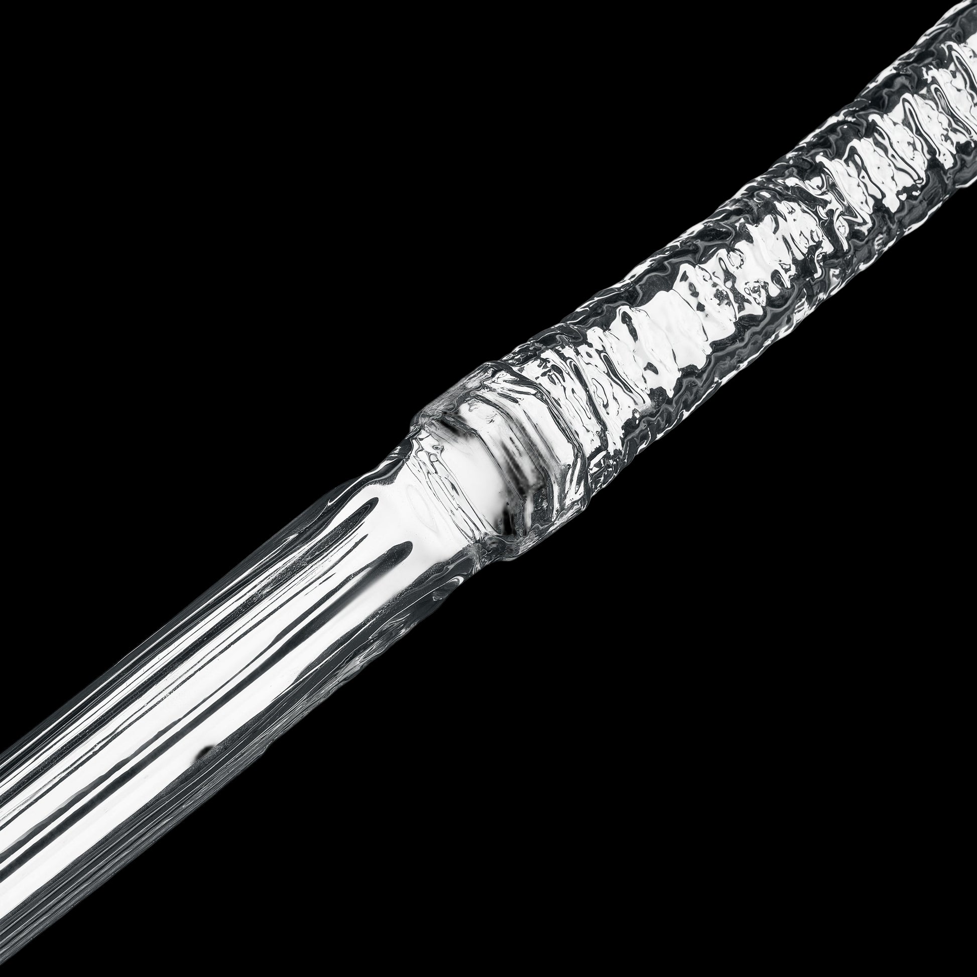 Close-up of a metallic object with a textured surface on a white background