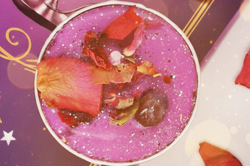 Close-up of a purple dessert with rose petals on a decorative background