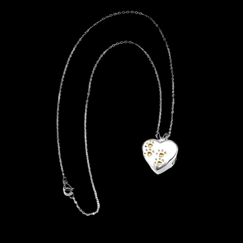 Heart-shaped pendant necklace with embedded stones on a white background