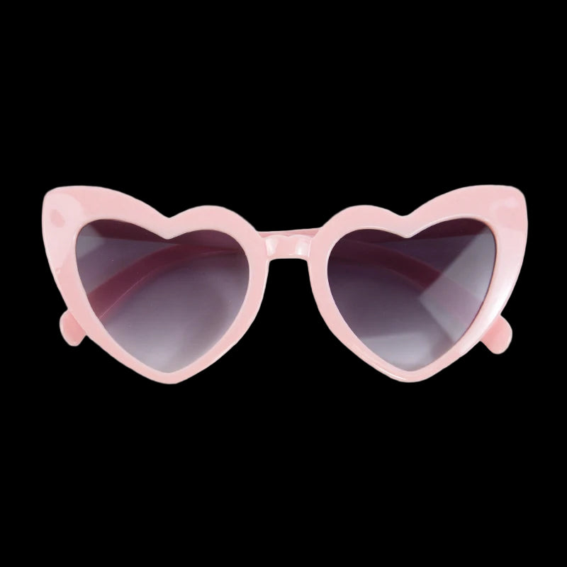 Heart-shaped sunglasses with pink frame on a white background