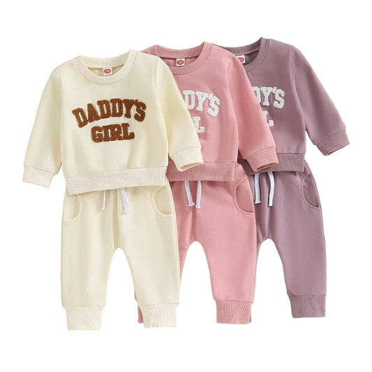 Three children's sweatshirt and pants sets with 'DADDY'S GIRL' text on a beige background.