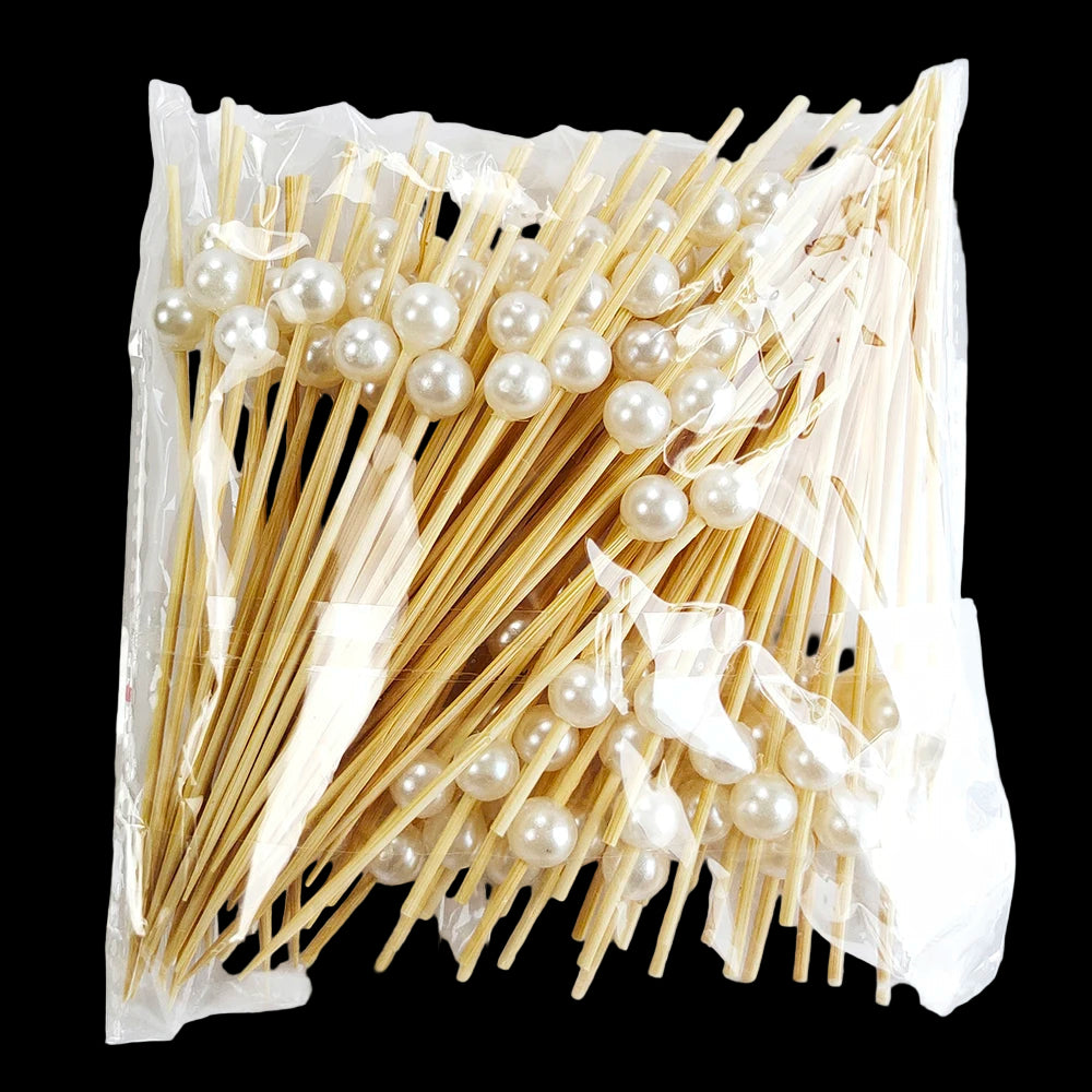 Packaged skewers with pearls on a white background