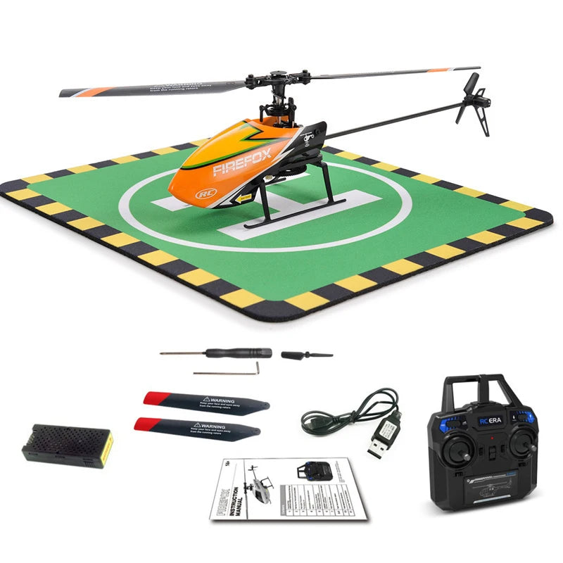 RC helicopter with accessories on a green mat with black and yellow border