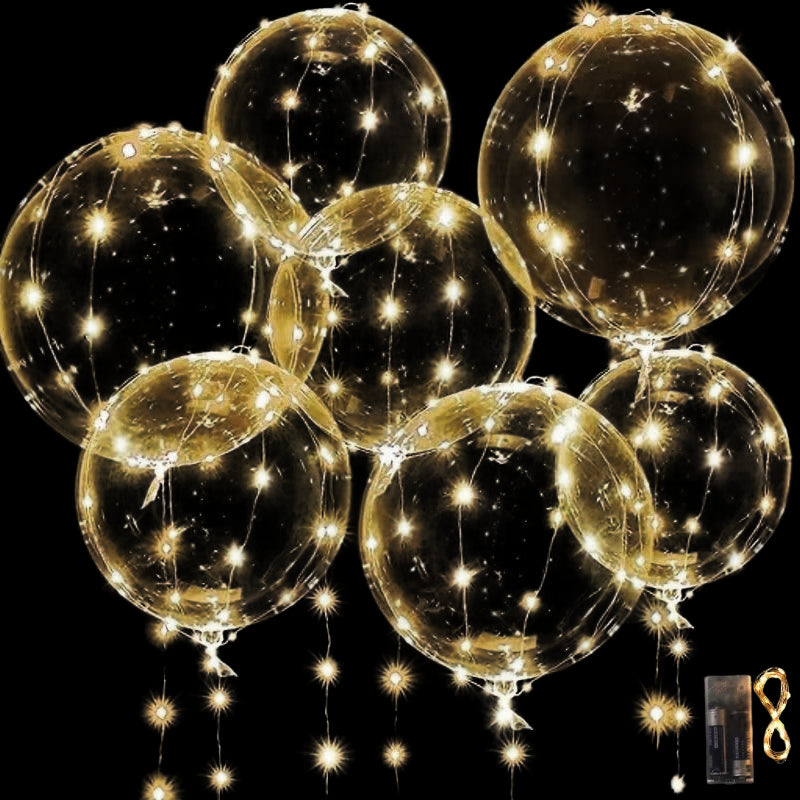 Clear balloons with string lights on a black background