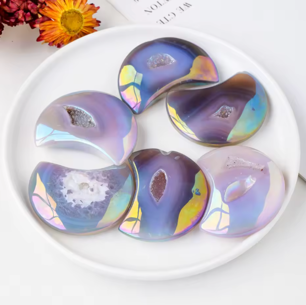 Colorful, iridescent cookies on a white plate with flowers in the background