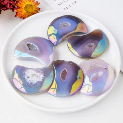 Colorful, iridescent cookies on a white plate with flowers in the background
