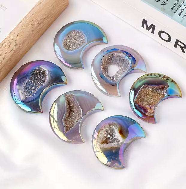 Iridescent half-circle coasters with natural stone centers on a white surface.