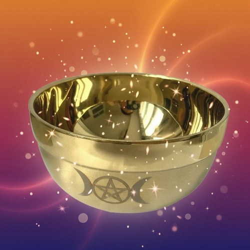 Gold bowl with a pentacle design on a white background