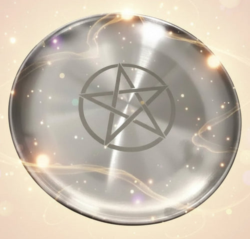 Metallic plate with a pentagram symbol on a plain background